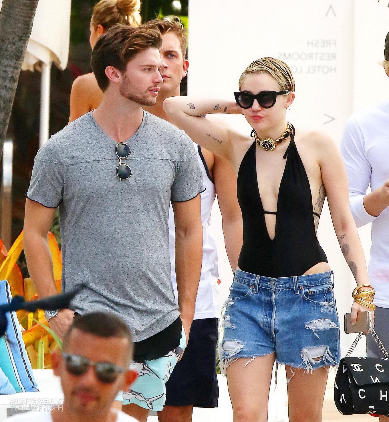 16P Miley Cyrus wearing swimsuit and hotpants at a pool in Miami