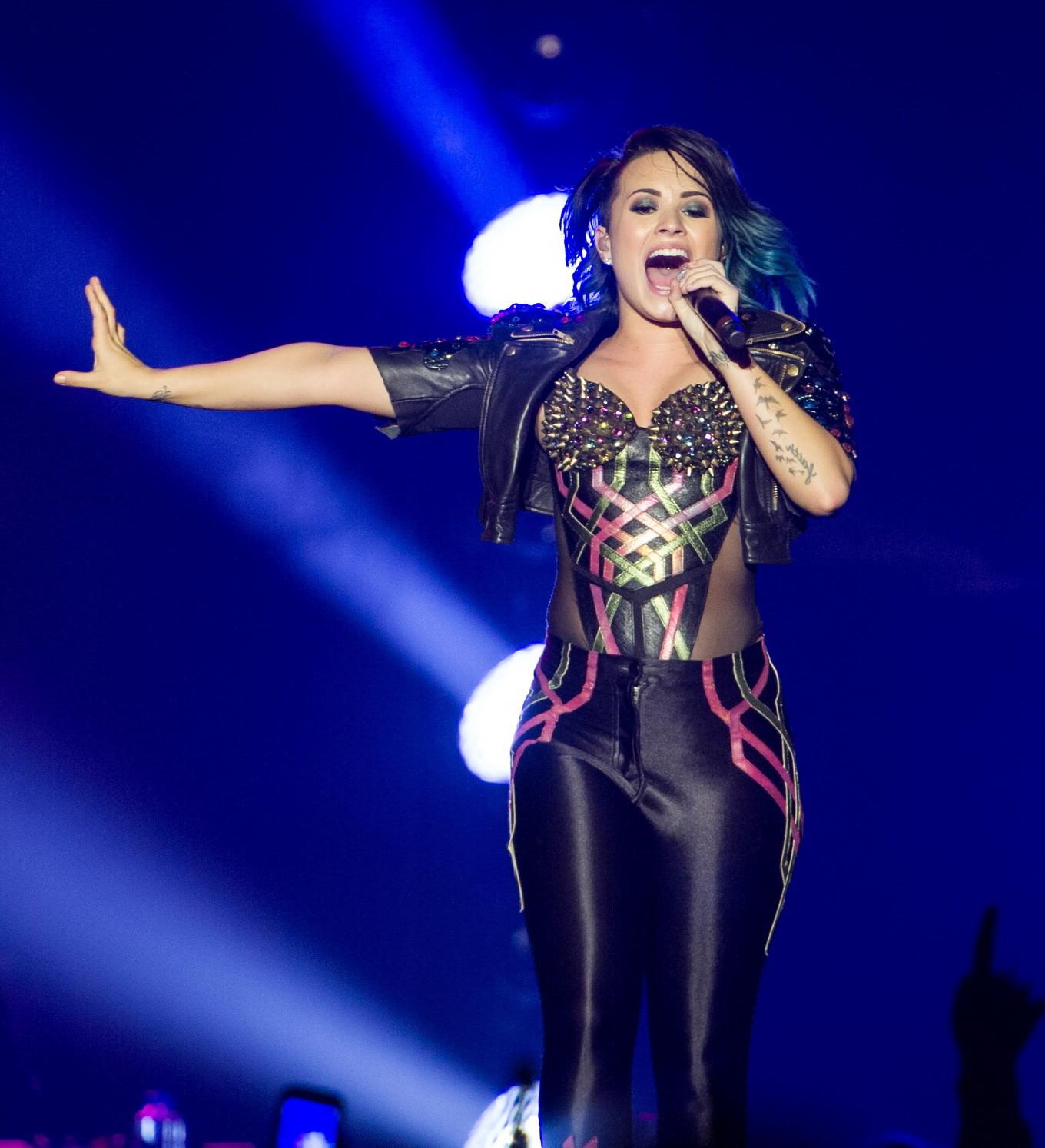 16P Demi Lovato wearing tights and spiky corset on stage in Birmingham