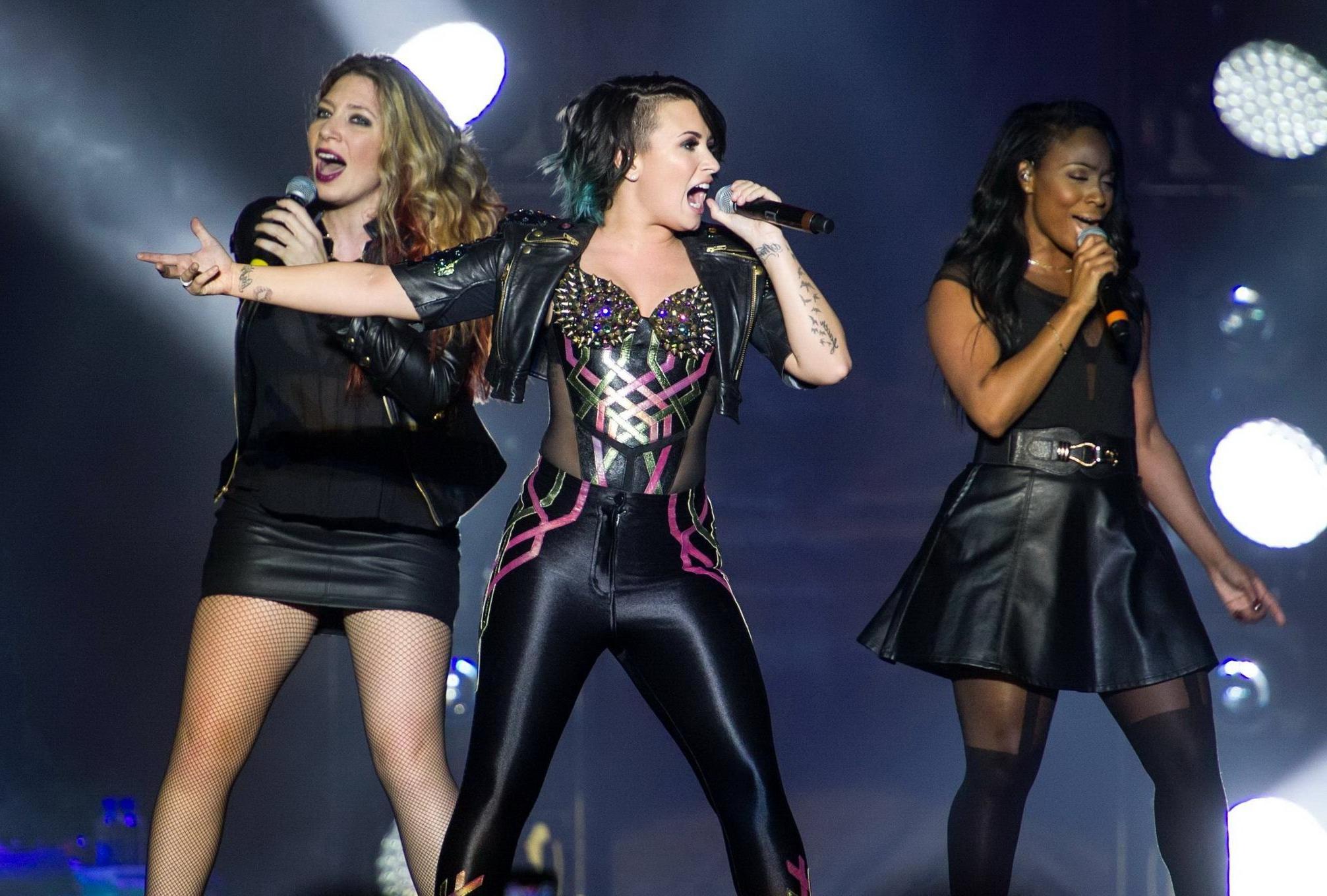 16P Demi Lovato wearing tights and spiky corset on stage in Birmingham