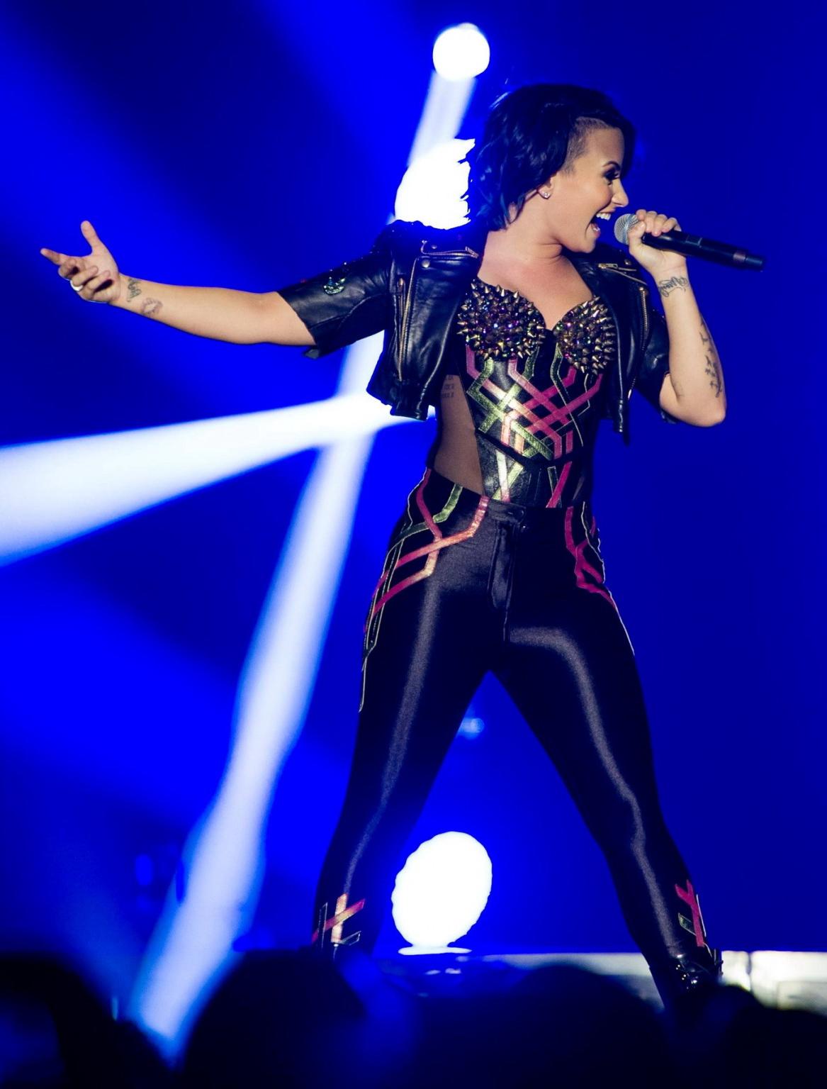16P Demi Lovato wearing tights and spiky corset on stage in Birmingham