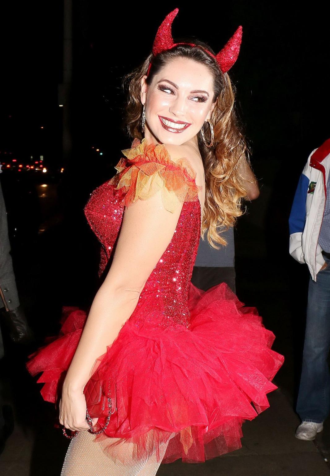 16P Kelly Brook busty and leggy in tiny red devil costume and stockings at Halloween
