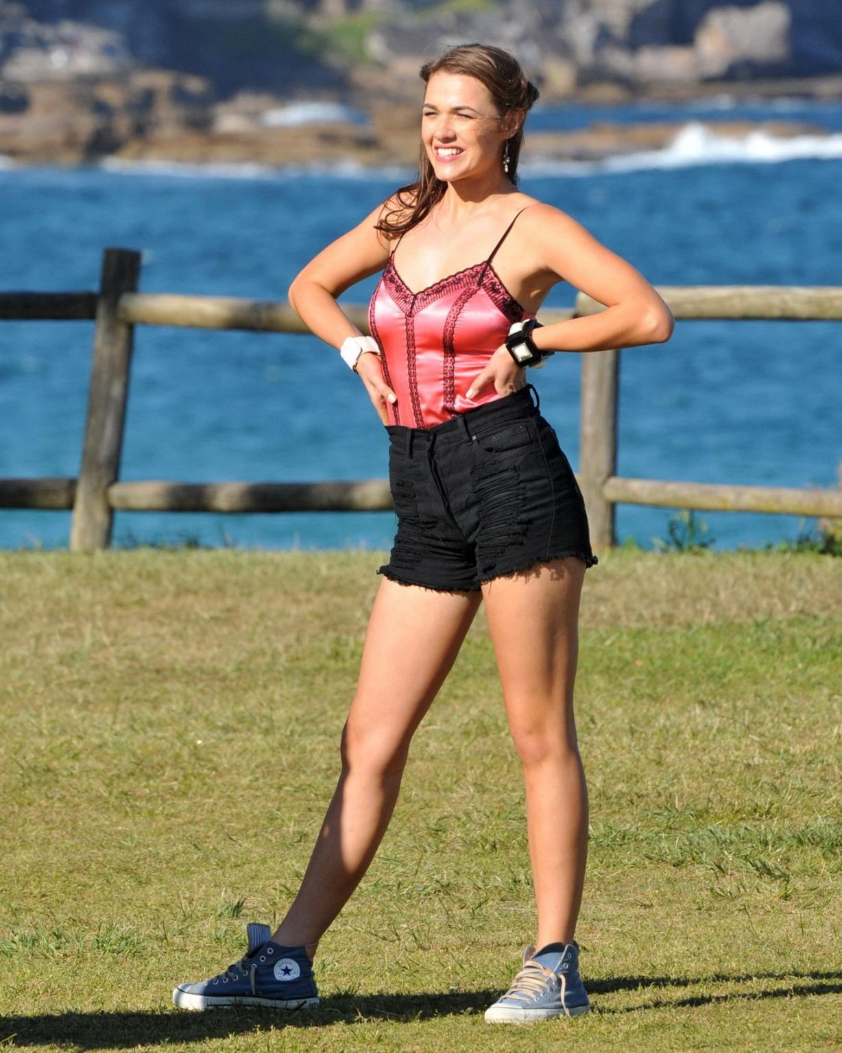 16P Demi Harman wearing a corset and black shorts on Home  Away set at Palm Beach in