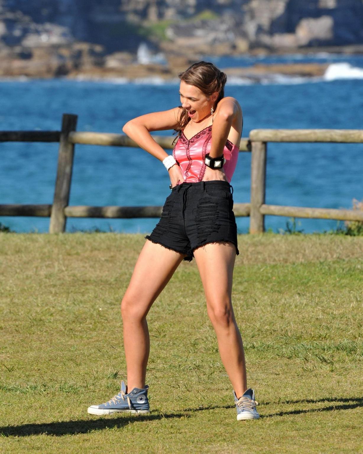 16P Demi Harman wearing a corset and black shorts on Home  Away set at Palm Beach in