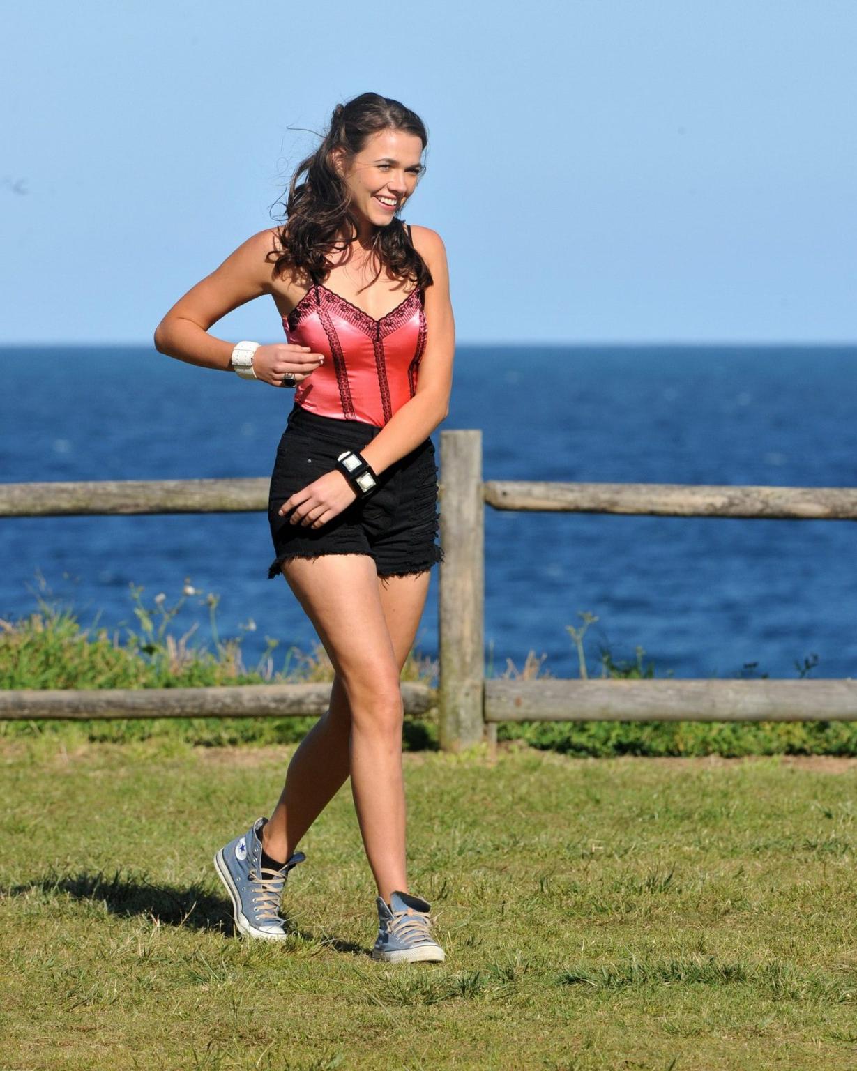 16P Demi Harman wearing a corset and black shorts on Home  Away set at Palm Beach in