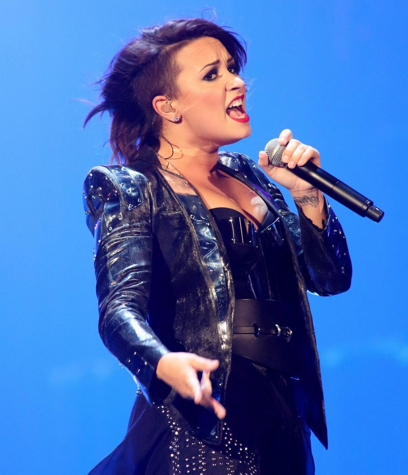 16P Demi Lovato in leather pants and metal corset performing on stage in Baltimore