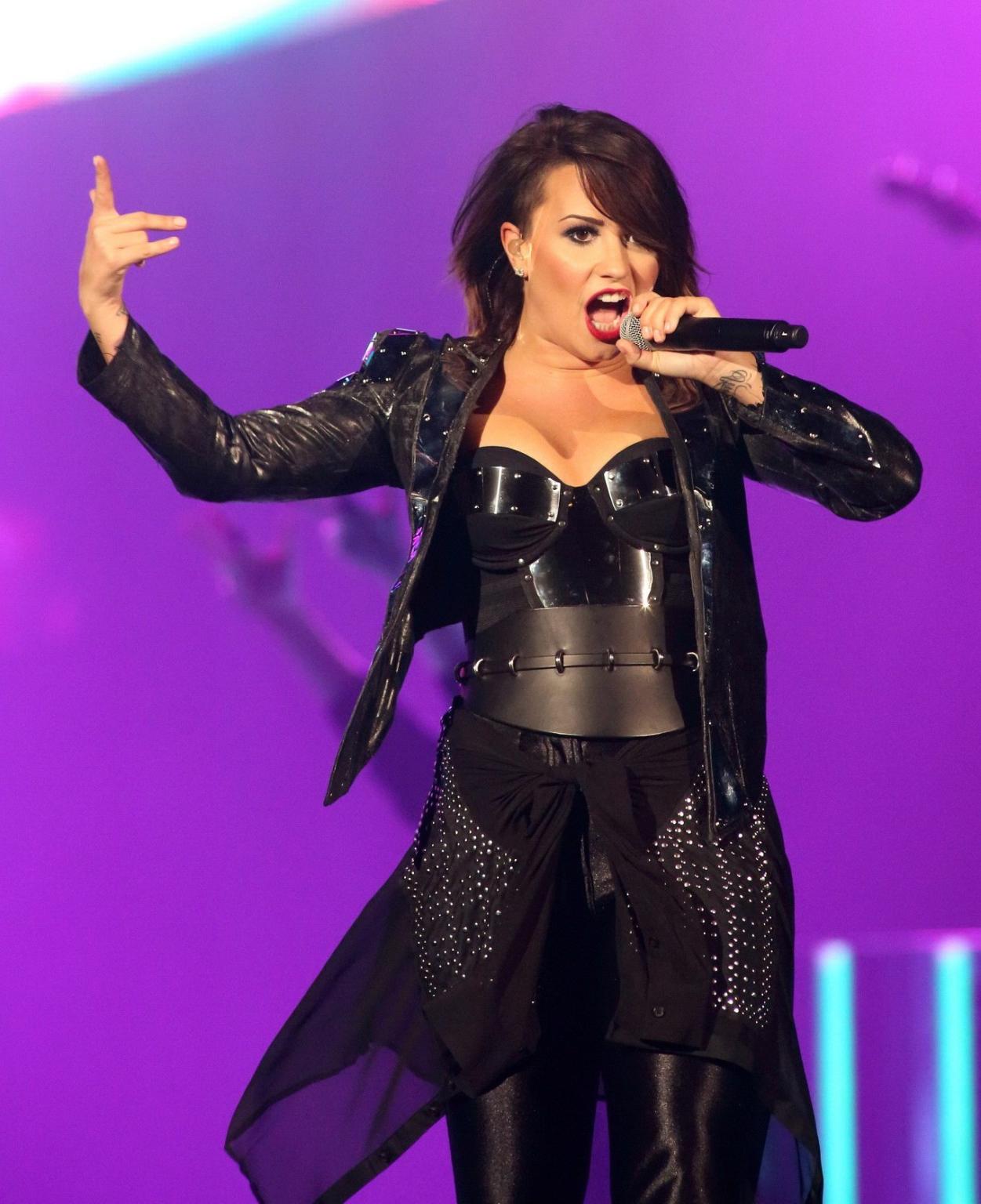 16P Demi Lovato in leather pants and metal corset performing on stage in Baltimore