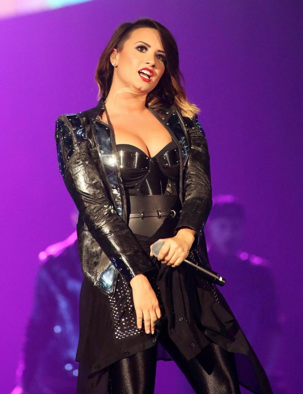 16P Demi Lovato in leather pants and metal corset performing on stage in Baltimore