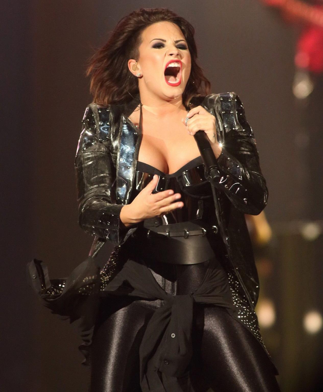 16P Demi Lovato in leather pants and metal corset performing on stage in Baltimore