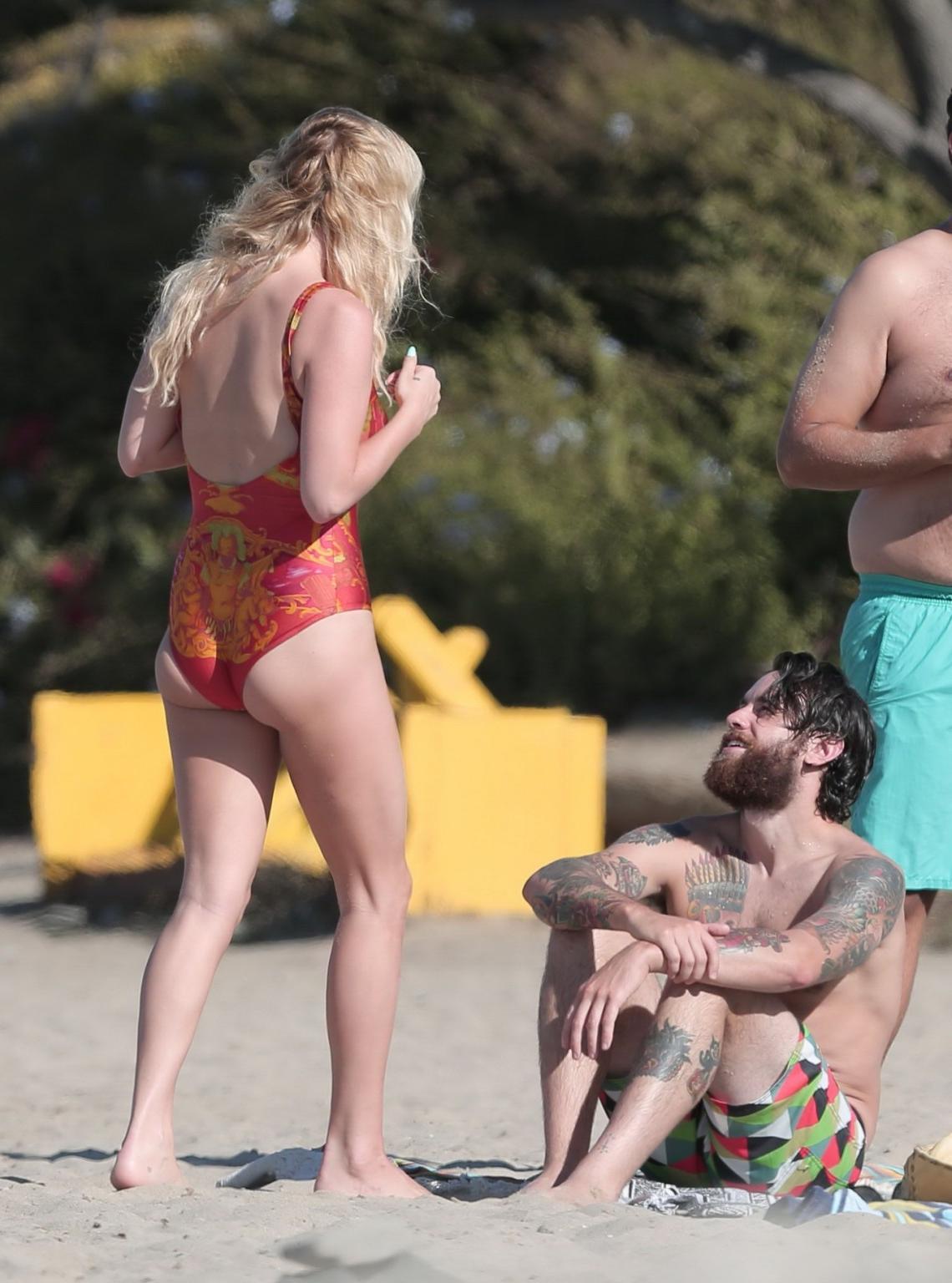 16P Kesha Sebert busty and booty in a red plunging swimsuit at the beach in Malibu