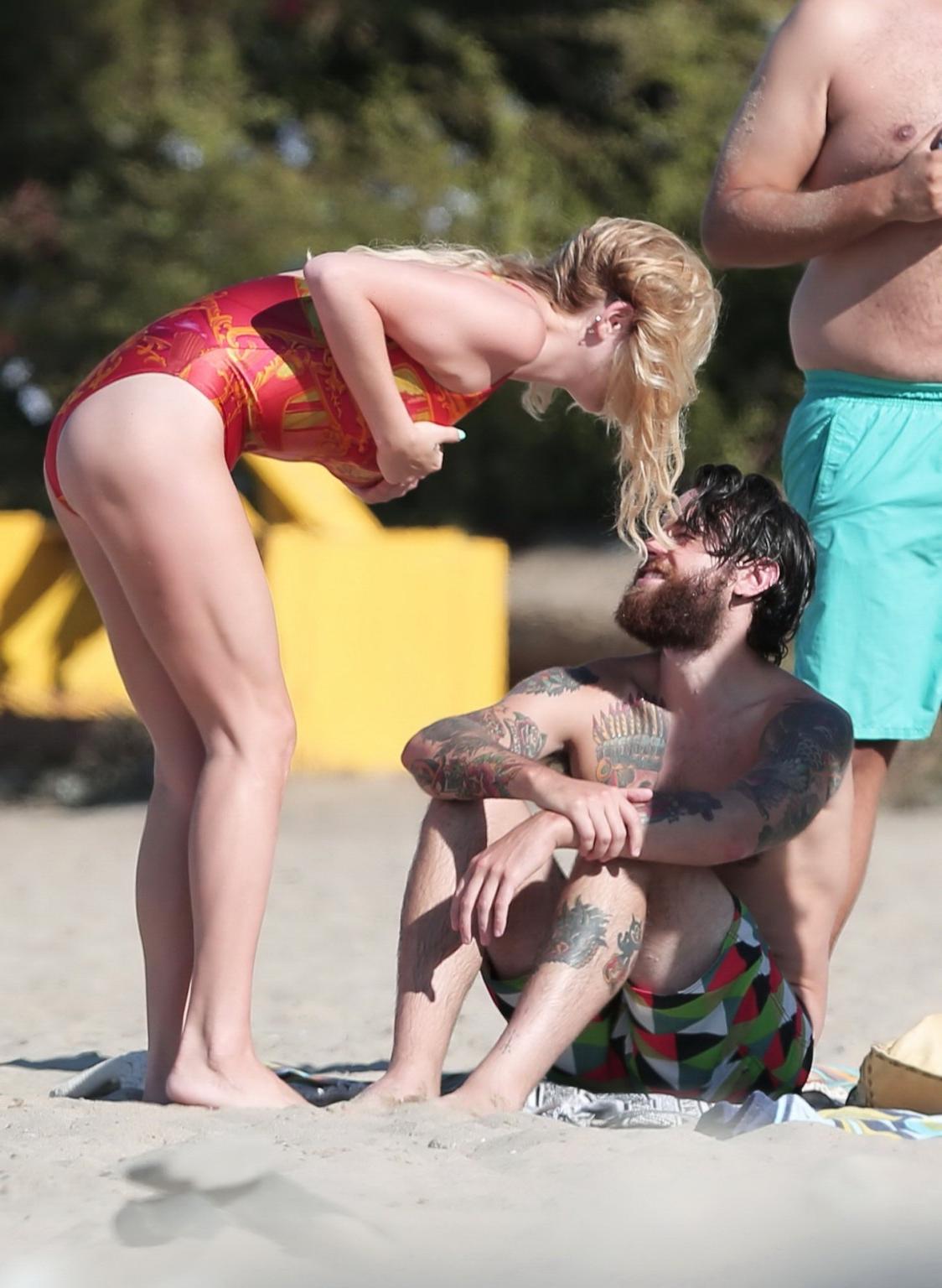 16P Kesha Sebert busty and booty in a red plunging swimsuit at the beach in Malibu