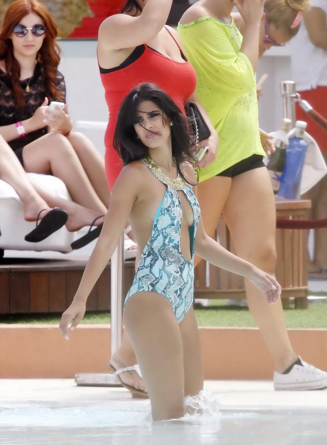 16P Jasmin Walia slips from her tiny blue snake print swimsuit poolside in Ibiza