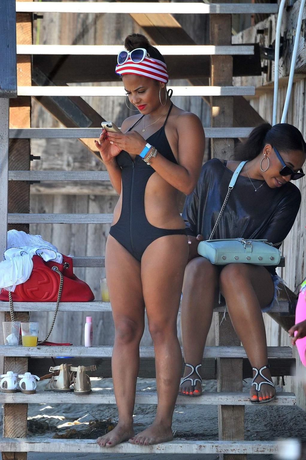 16P Christina Milian wearing a sexy black swimsuit at Paris Hiltons 4th of July part
