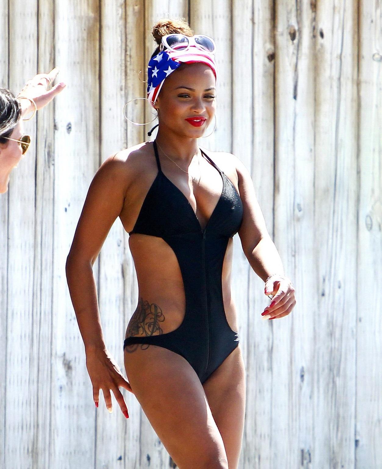 16P Christina Milian wearing a sexy black swimsuit at Paris Hiltons 4th of July part