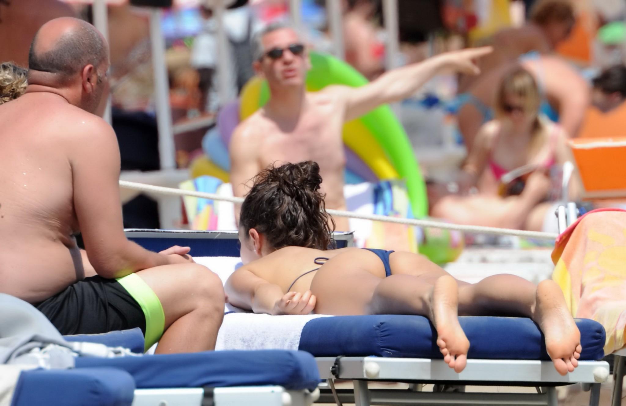 16P Laura Barriales shows off her skinny ass in tiny blue string bikini on the beach