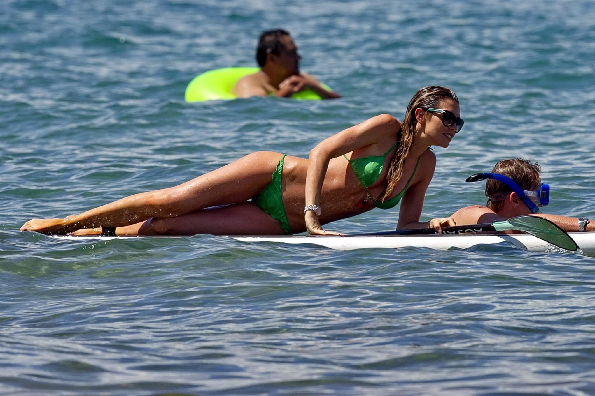 16P Abigail Clancy showing off her bikini body while paddleboarding on a Hawaiian be
