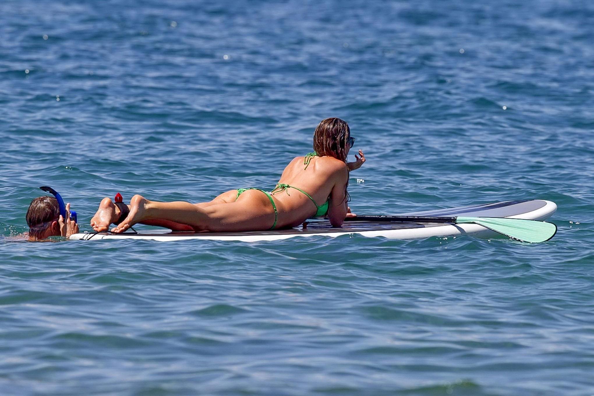 16P Abigail Clancy showing off her bikini body while paddleboarding on a Hawaiian be