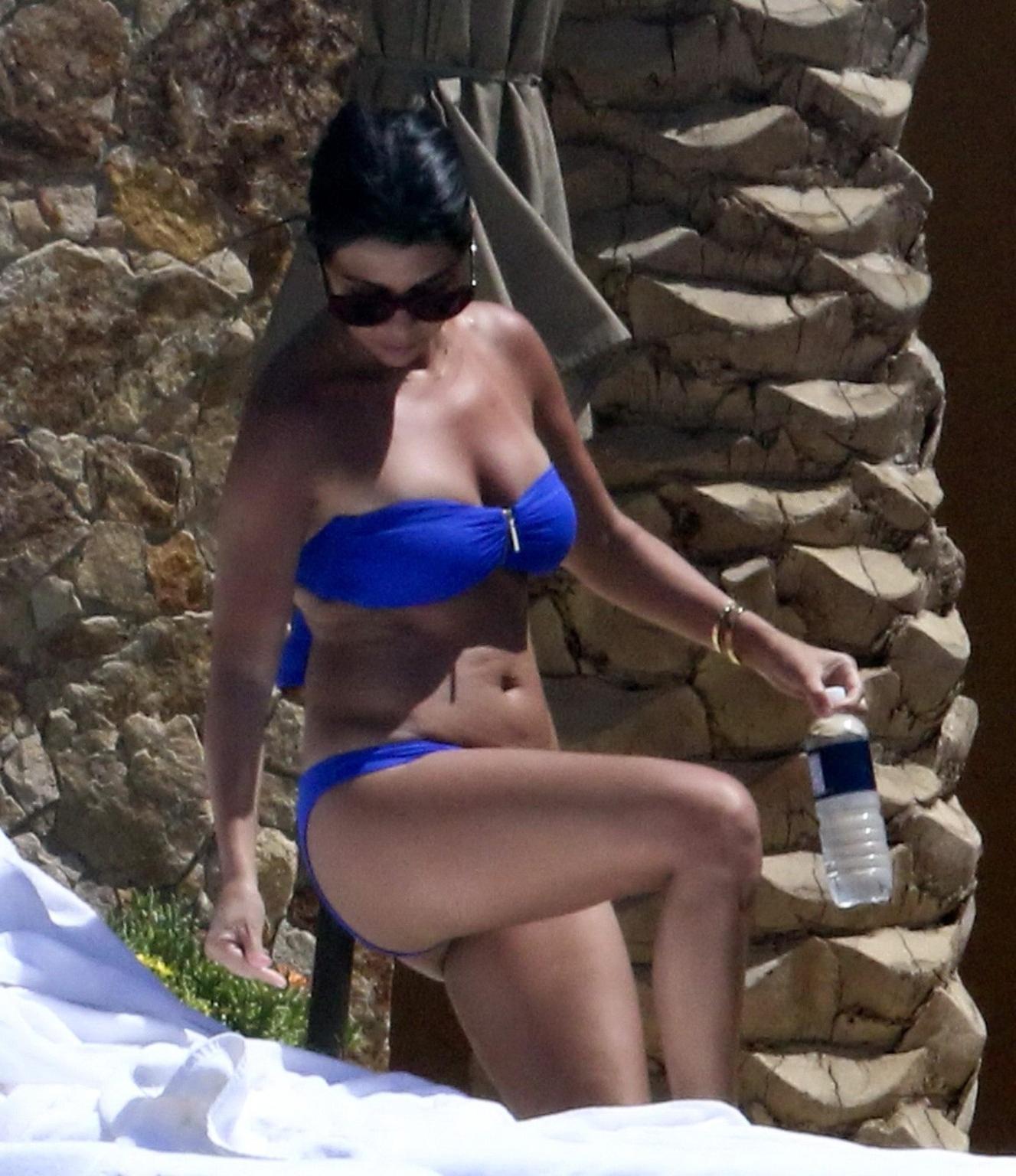 16P Kourtney Kardashian wearing blue tube bikini poolside in Mexico