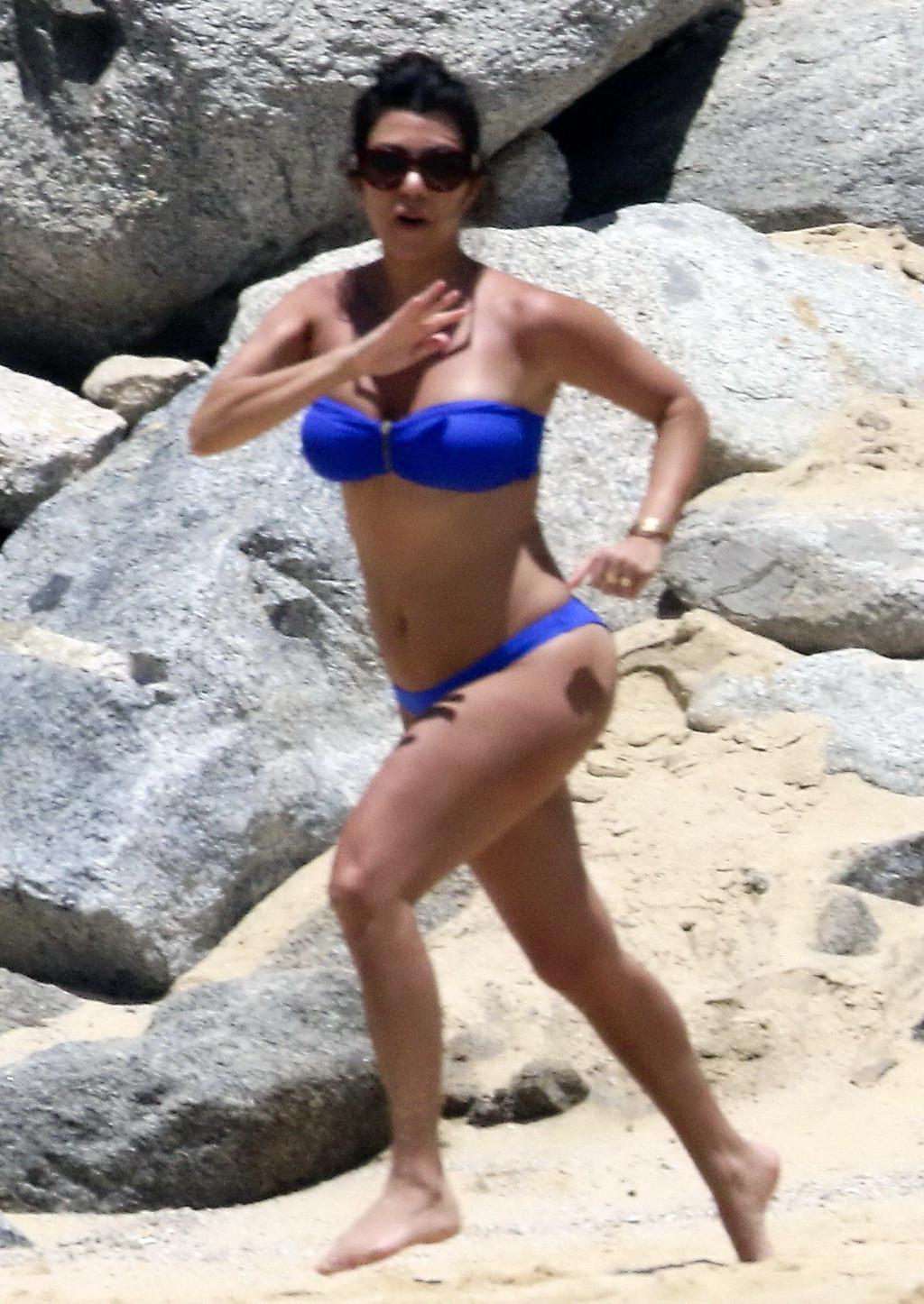 16P Kourtney Kardashian wearing blue tube bikini poolside in Mexico