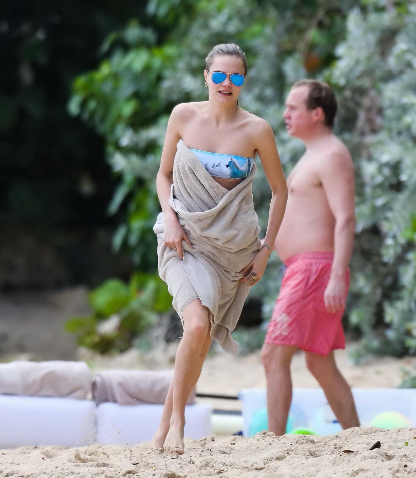 16P Cara Delevigne wearing tiny blue tube bikini at the beach in Barbados