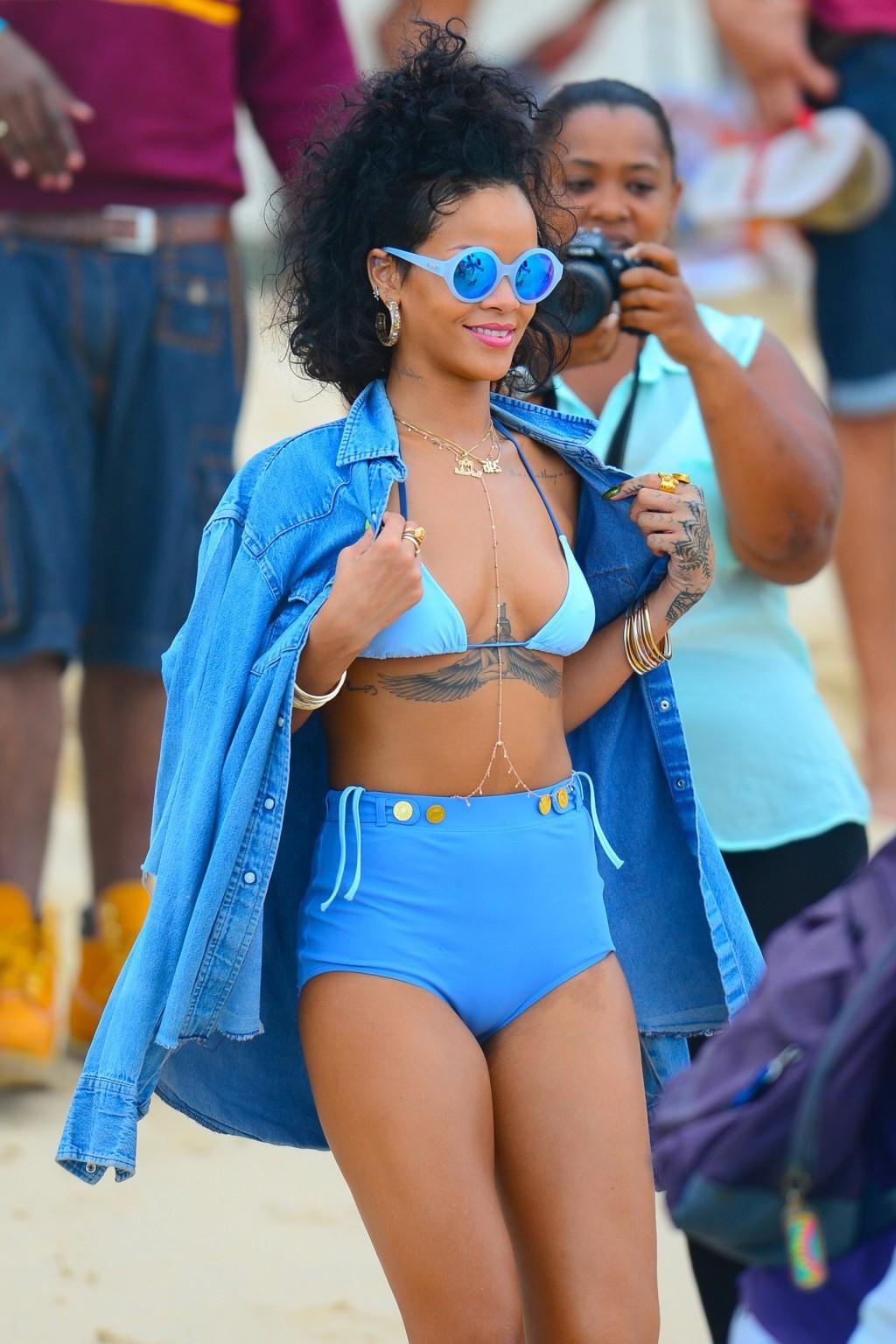 16P Rihanna showing off her hot body in a retro blue bikini at the beach in Barbados