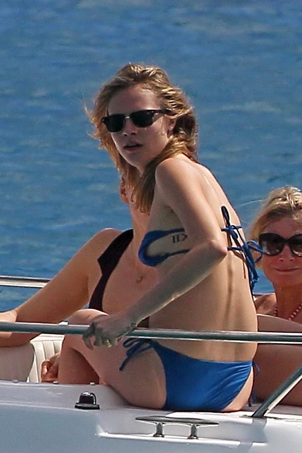 16P Cara Delevingne wearing a blue bikini on a beach in Barbados