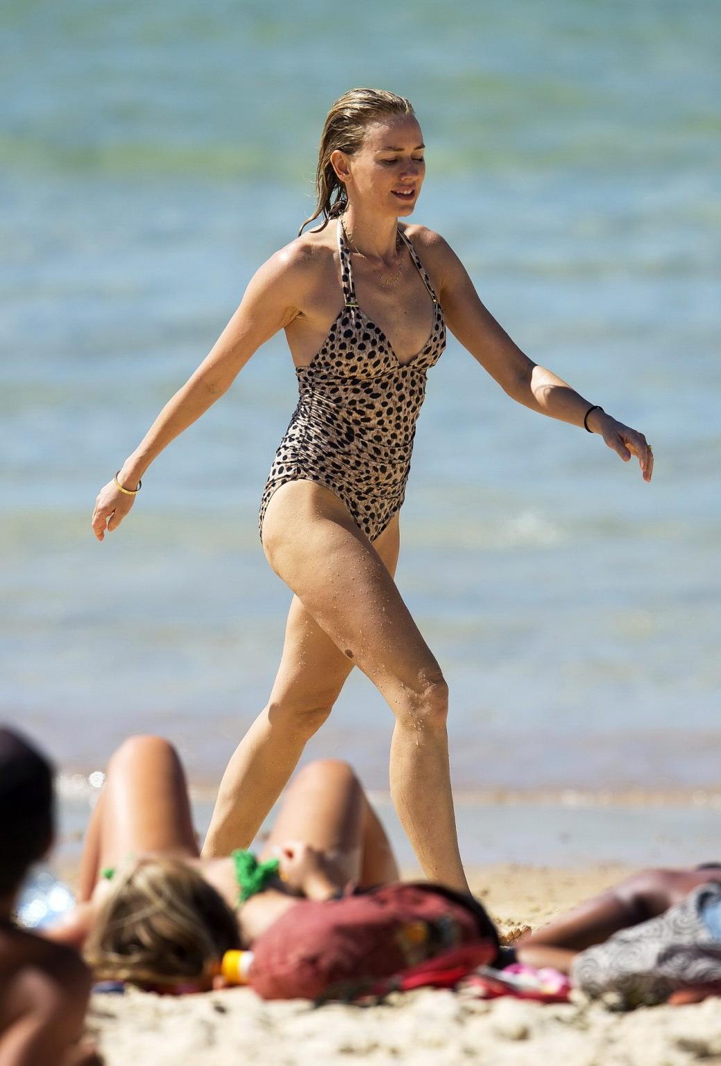 16P Naomi Watts wearing a cheetah print swimsuit on a beach in Australia