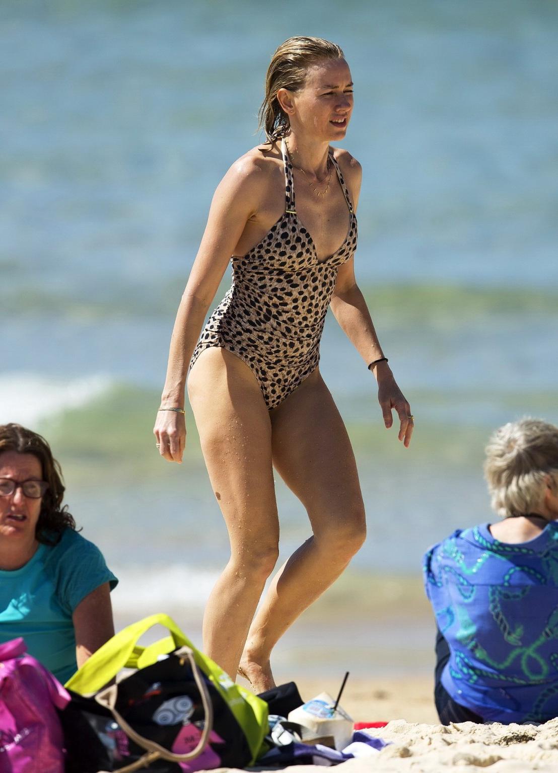 16P Naomi Watts wearing a cheetah print swimsuit on a beach in Australia