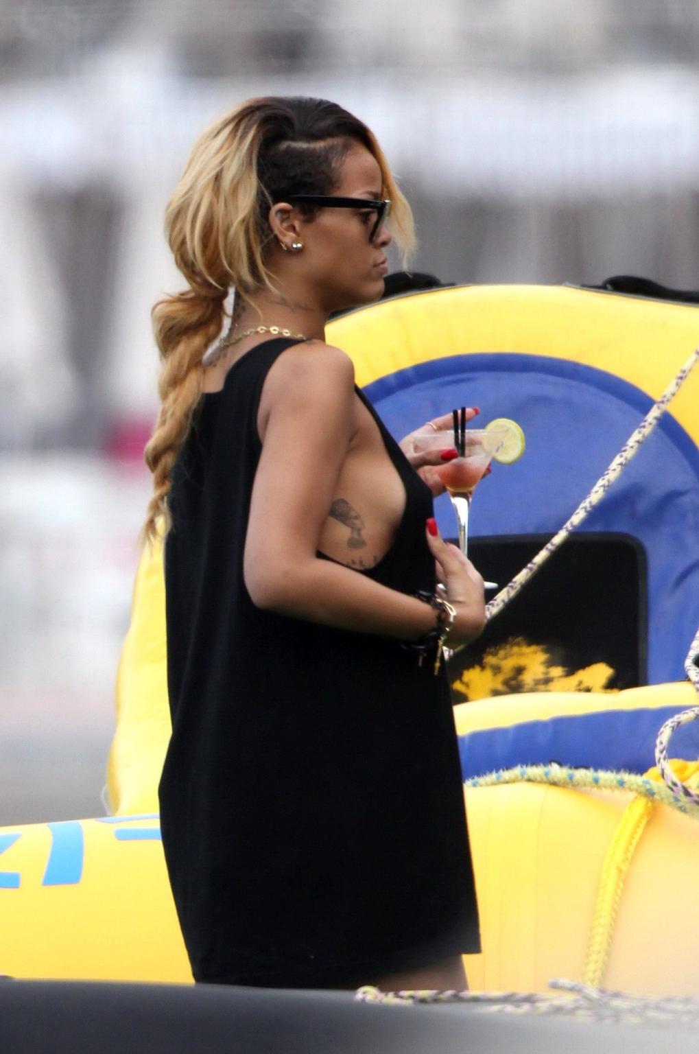 16P Rihanna wearing a bikini bottom  a see through top on a boat in Monaco