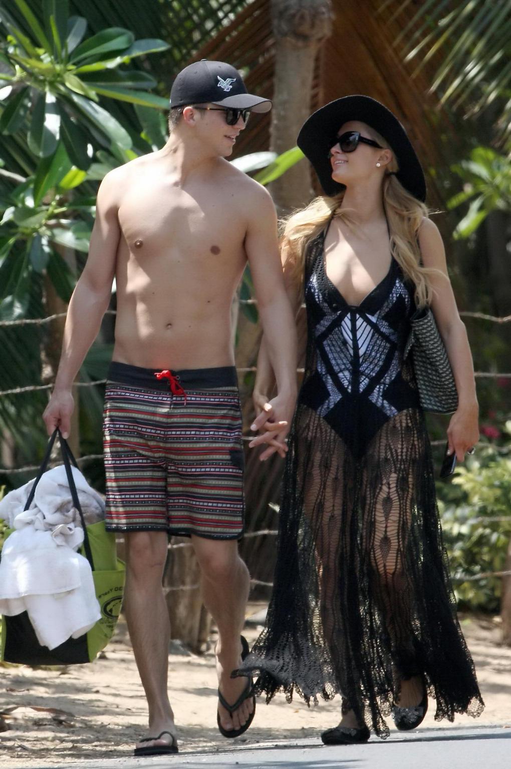 16P Paris Hilton wearing a swimsuit  a see through lace dress on a beach in Hawaii