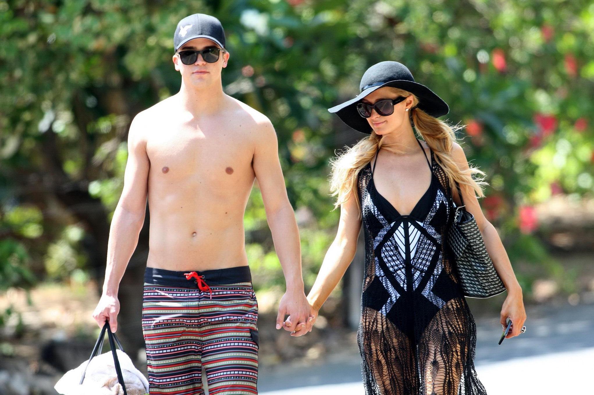 16P Paris Hilton wearing a swimsuit  a see through lace dress on a beach in Hawaii