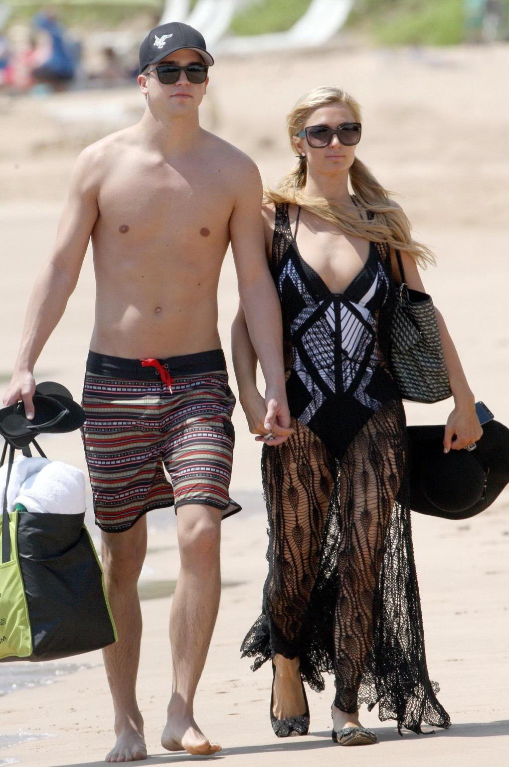 16P Paris Hilton wearing a swimsuit  a see through lace dress on a beach in Hawaii