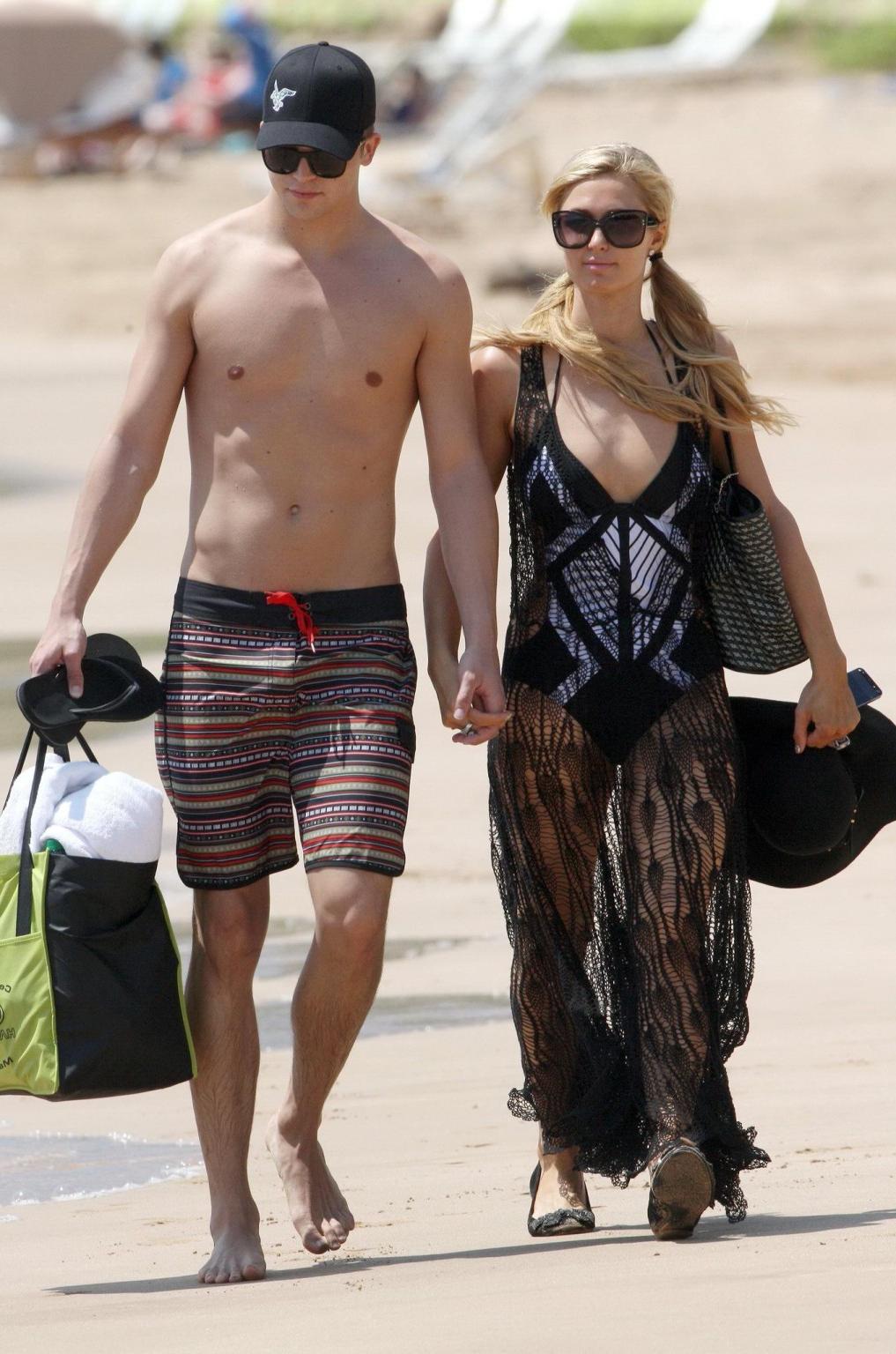 16P Paris Hilton wearing a swimsuit  a see through lace dress on a beach in Hawaii