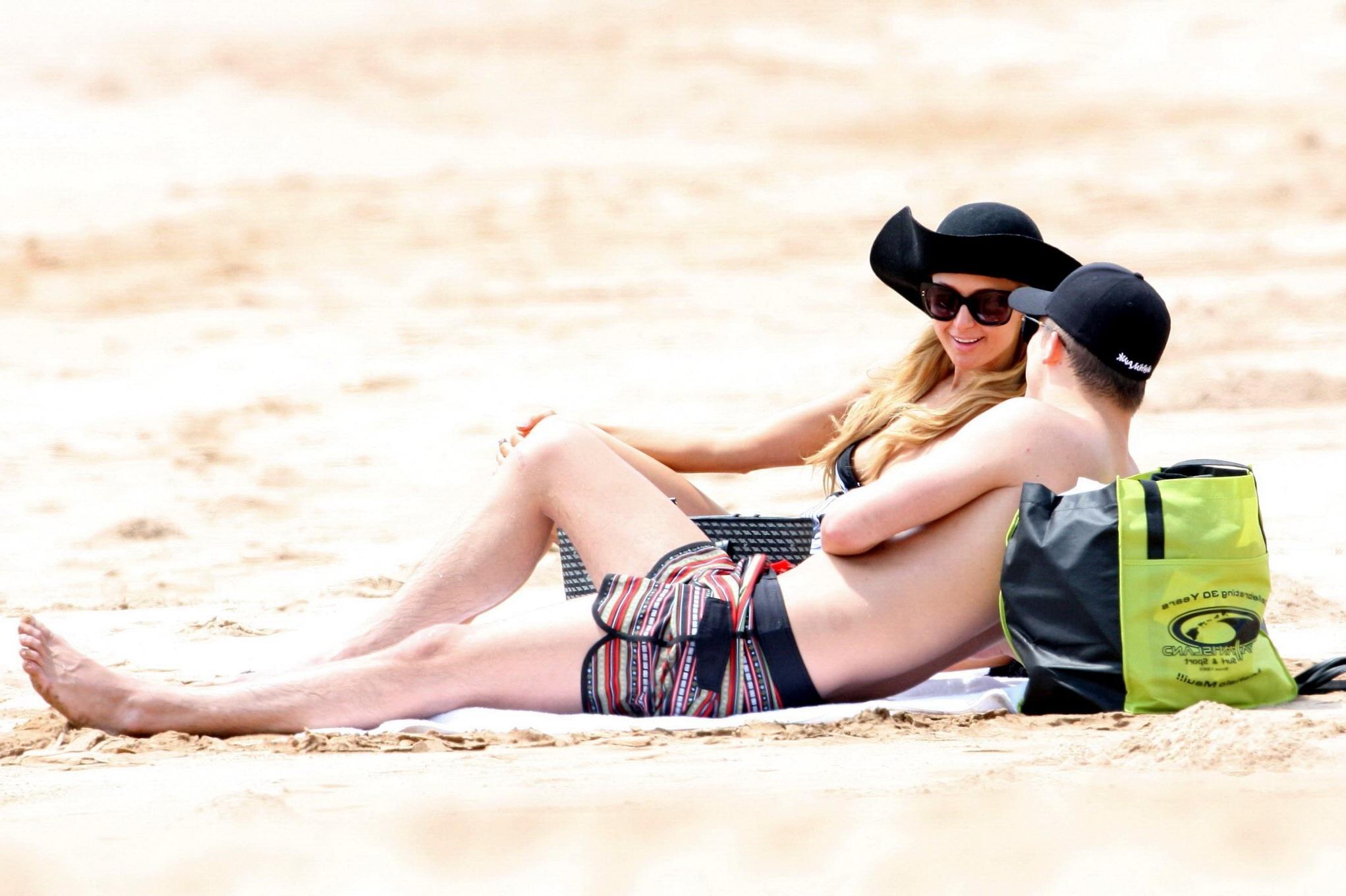 16P Paris Hilton wearing a swimsuit  a see through lace dress on a beach in Hawaii