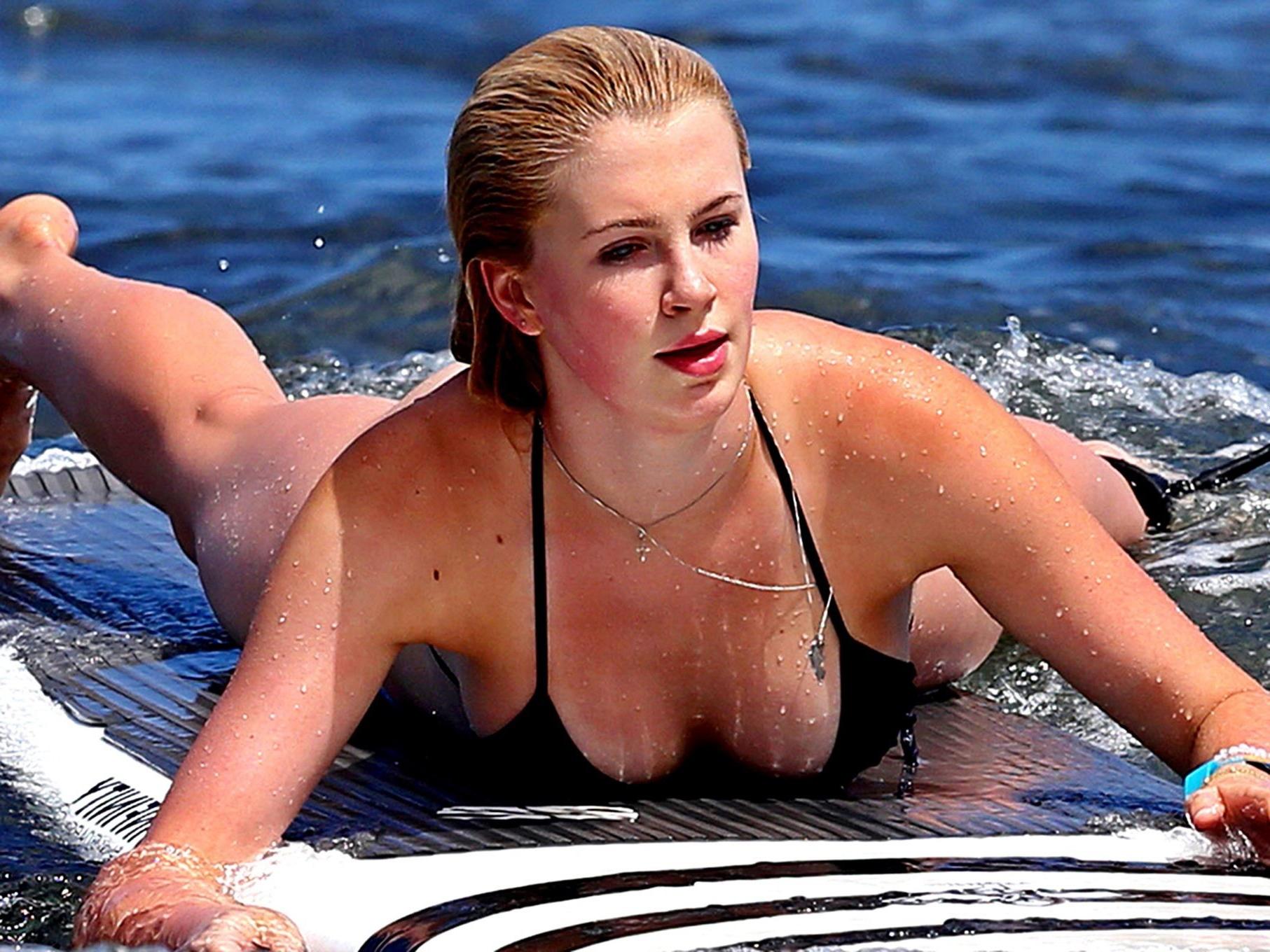 16P Ireland Baldwin in bikini paddle surfing on a Hawaiian beach