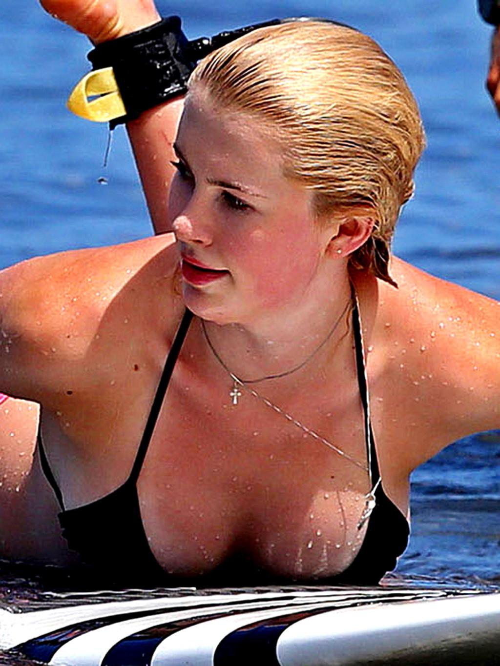 16P Ireland Baldwin in bikini paddle surfing on a Hawaiian beach