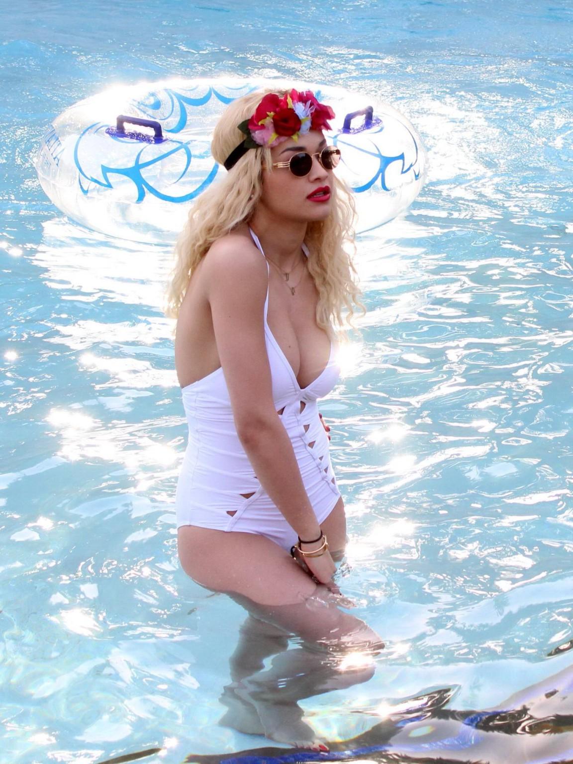 10P Rita Ora busty wearing a white slightly see through swimsuit at the pool in Duba