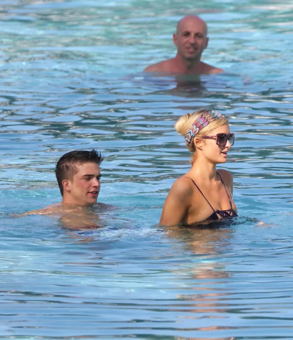 10P Paris Hilton showing off her hot body in skimpy multi colored swimsuit at a pool