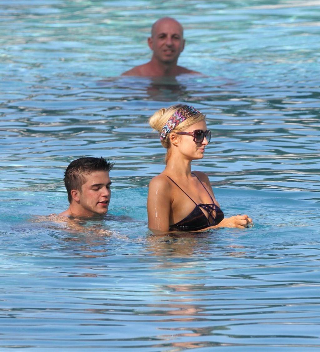 10P Paris Hilton showing off her hot body in skimpy multi colored swimsuit at a pool