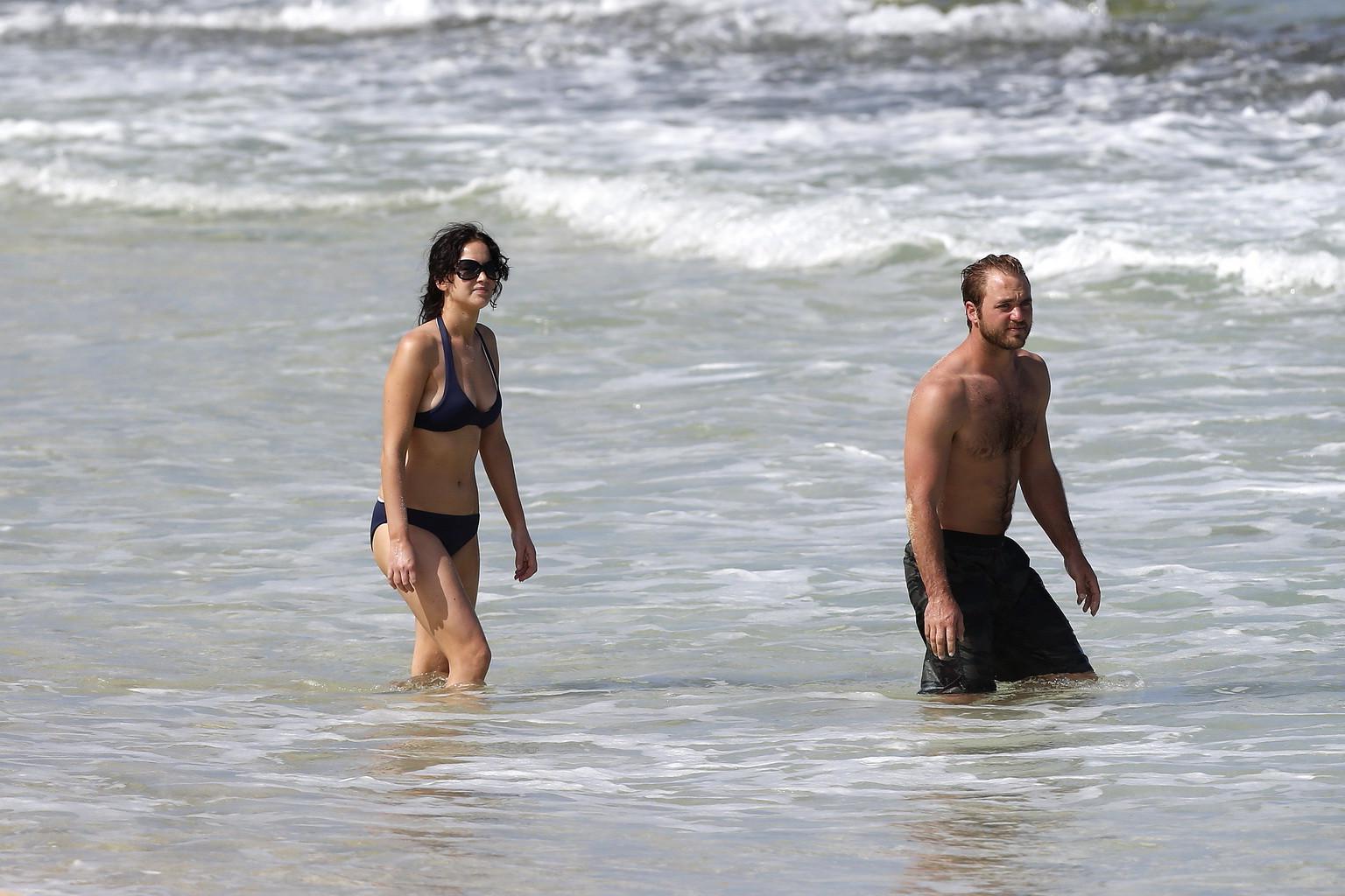 10P Jennifer Lawrence wearing skimpy dark blue bikini at a beach in Hawaii