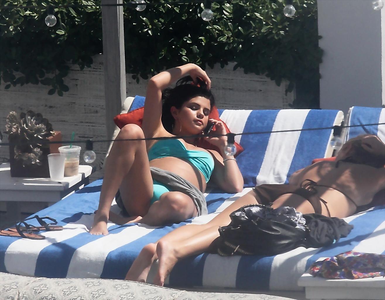10P Selena Gomez showing cameltoe and big boobs in light blue tube bikini at a pool 