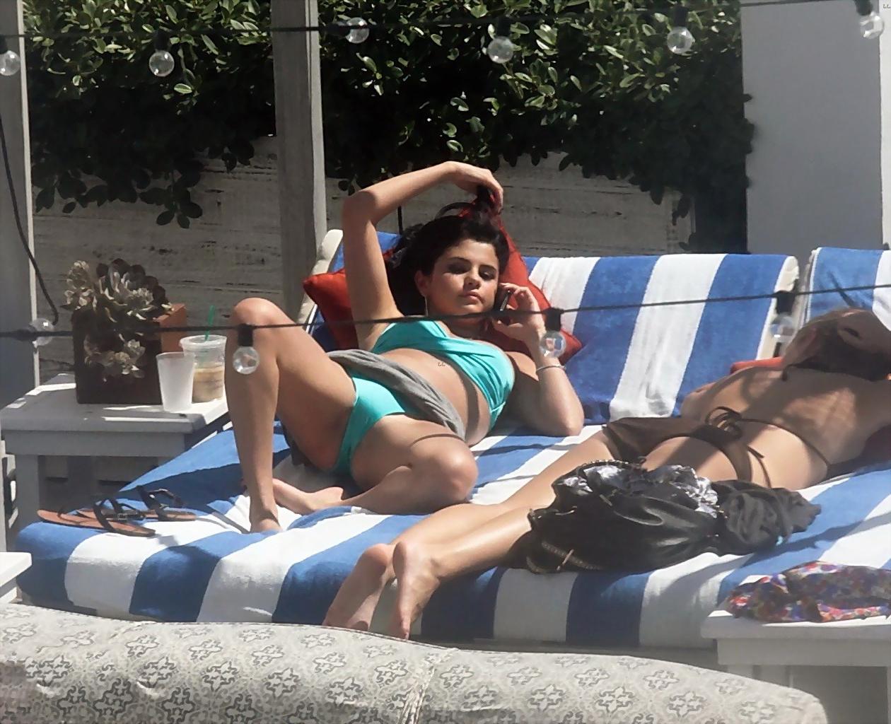 10P Selena Gomez showing cameltoe and big boobs in light blue tube bikini at a pool 
