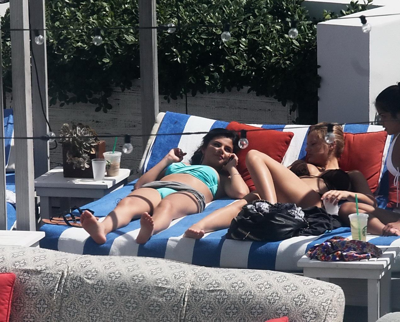 10P Selena Gomez showing cameltoe and big boobs in light blue tube bikini at a pool 