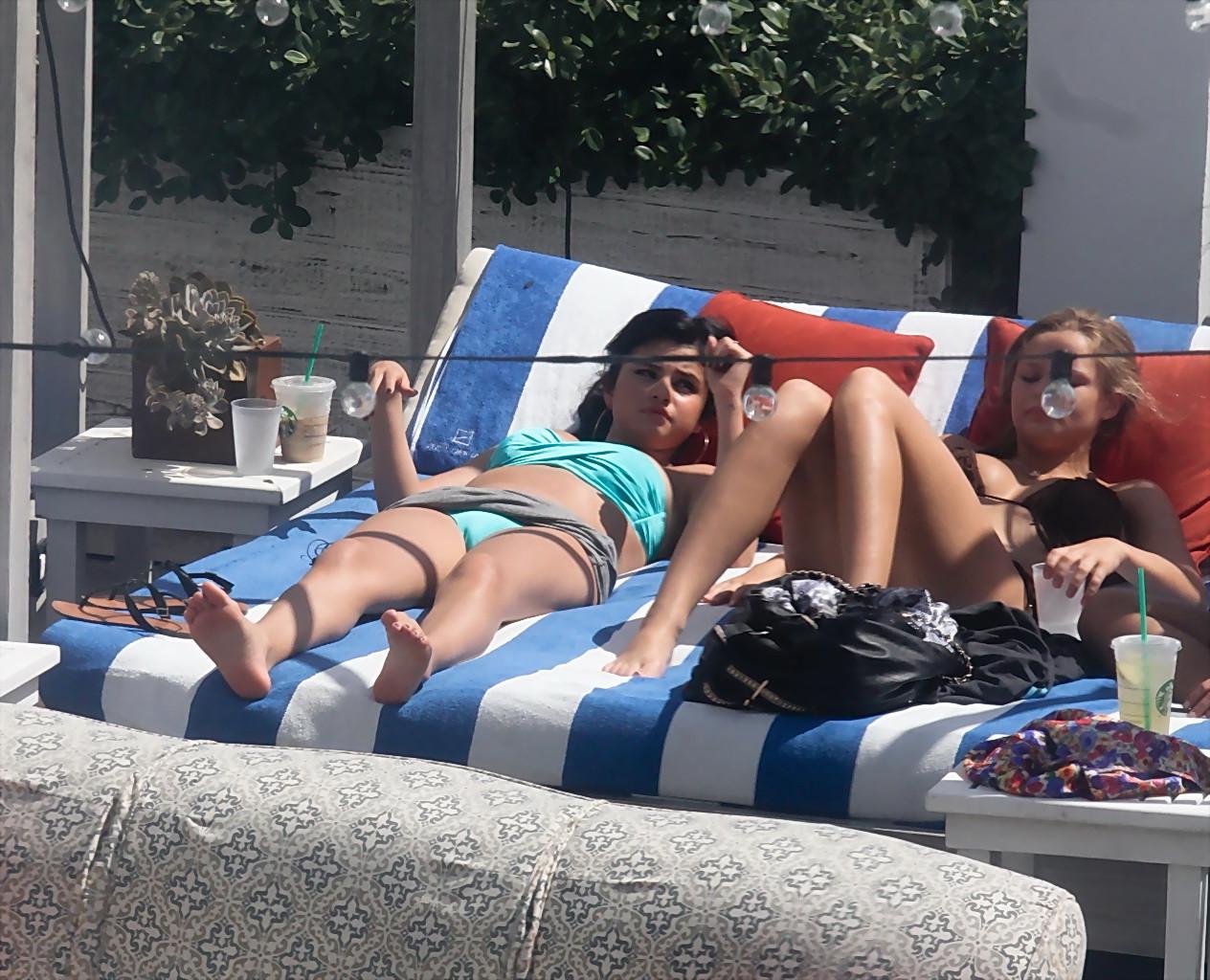 10P Selena Gomez showing cameltoe and big boobs in light blue tube bikini at a pool 