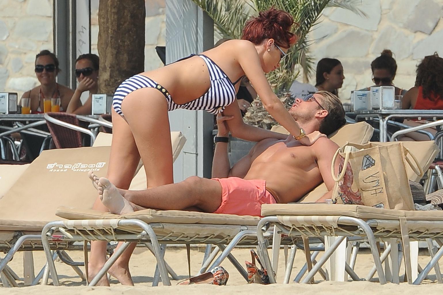 10P Busty babe Amy Chillds showing off her famos curves in skimpy swimsuit at the be