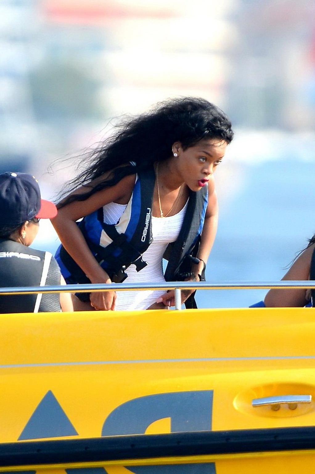 11P Rihanna in sexy white swimsuit posing on a boat in Cannes
