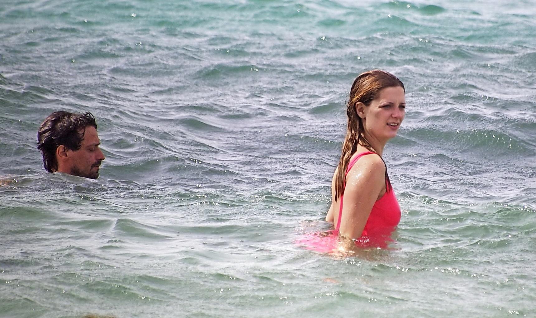 10P Mischa Barton showing pokies and round ass in wet pink swimsuit on the beach in 