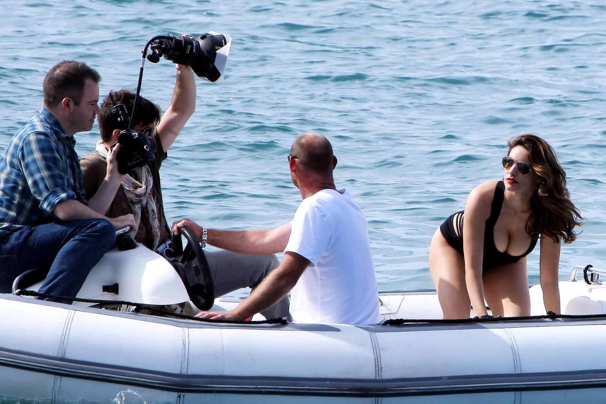 10P Kelly Brook busty wearing a skimpy black swimsuit at the photoshoot in Cannes