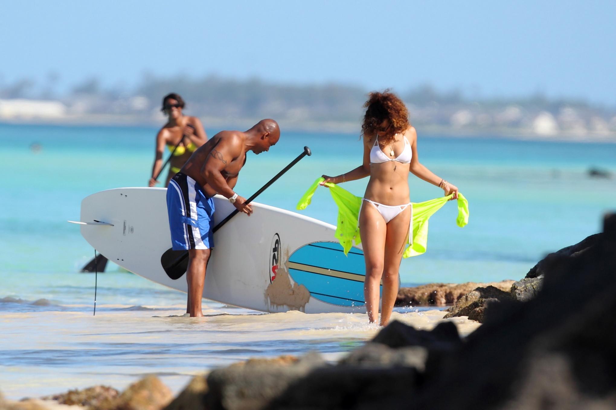 16P Rihanna paddle surfing in white bikini on a Hawaiian beach