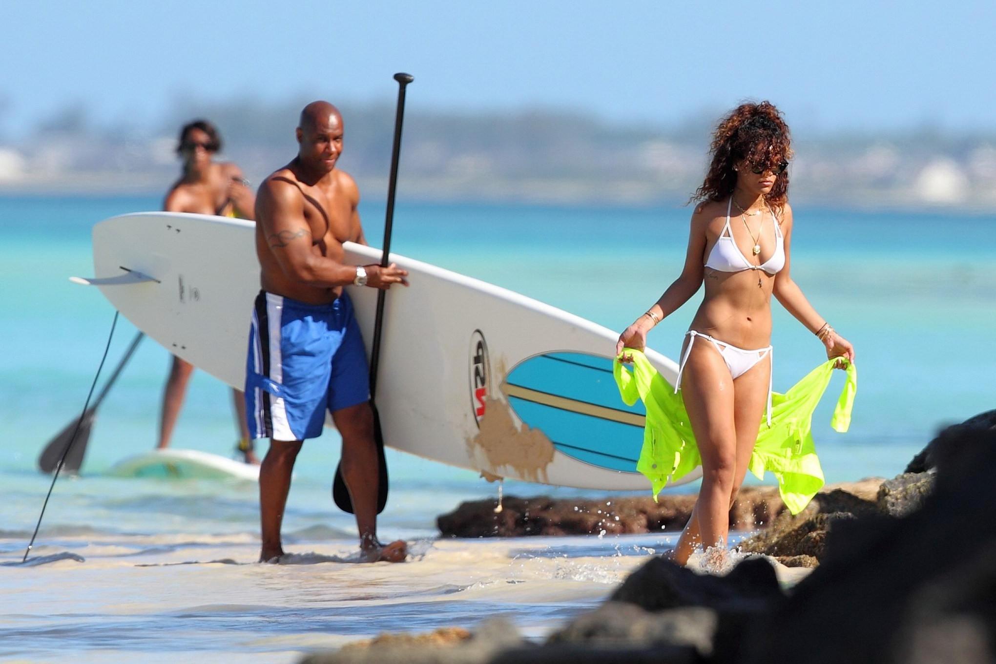 16P Rihanna paddle surfing in white bikini on a Hawaiian beach