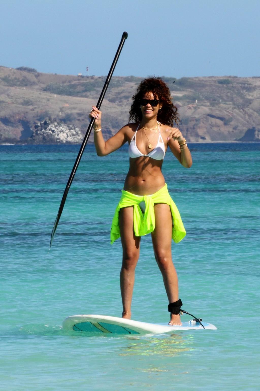 16P Rihanna paddle surfing in white bikini on a Hawaiian beach